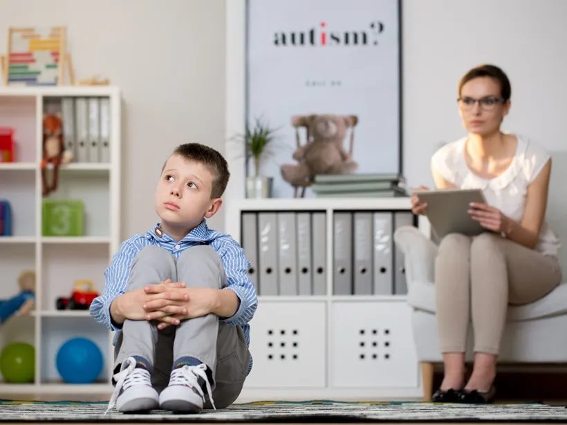 A therapist working encouragingly with a child